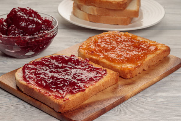 istock Toasts with jam on wooden board. Selective focus. 1353178110