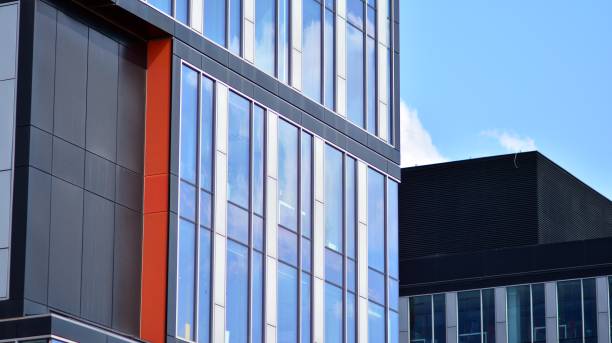 istock Modern office building with glass facade on a clear sky background. 1353179246