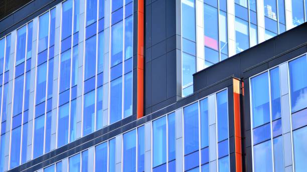 istock Modern office building with glass facade on a clear sky background. 1353179261