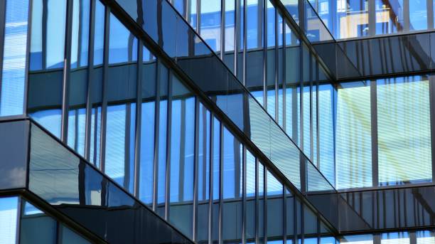 istock Modern office building with glass facade on a clear sky background. 1353179284