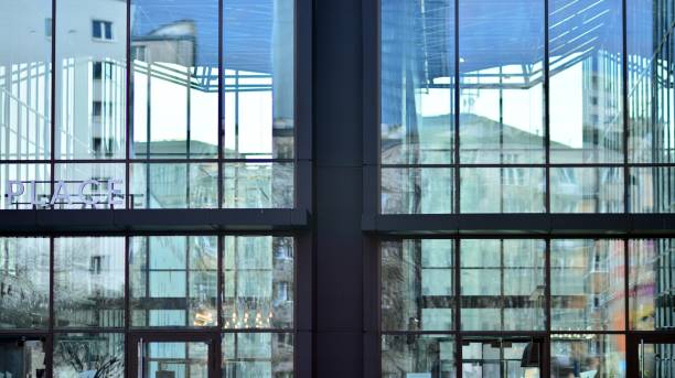 istock Modern office building with glass facade on a clear sky background. 1353179376
