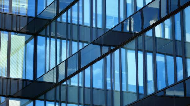 istock Modern office building with glass facade on a clear sky background. 1353179413