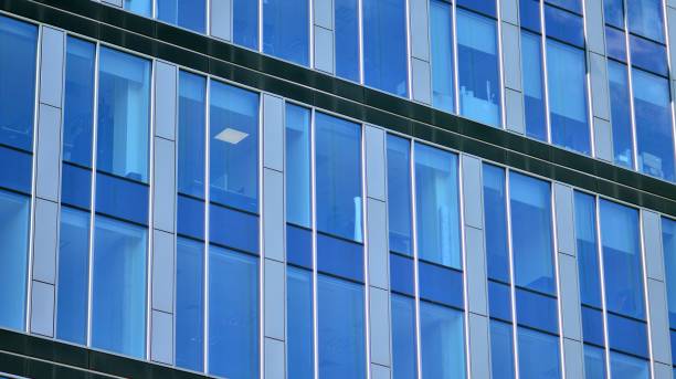 istock Modern office building with glass facade on a clear sky background. 1353179447
