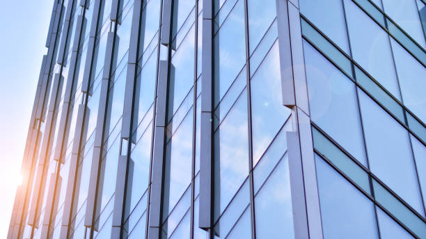 istock Modern office building with glass facade on a clear sky background. 1353179507