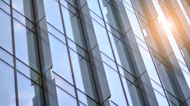 istock Modern office building with glass facade on a clear sky background. 1353179527