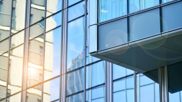 istock Modern office building with glass facade on a clear sky background. 1353180211