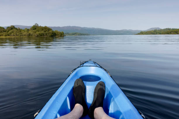 blue kayak in loch lomond on open water - loch rowboat lake landscape imagens e fotografias de stock