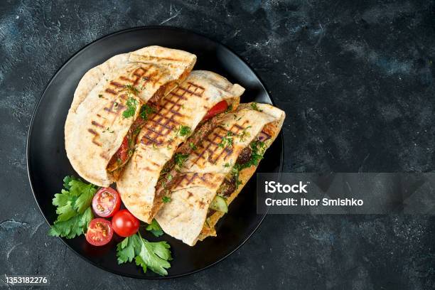 Three Pita Bread With Vegetables Chicken And Beef In A Black Plate On A Dark Background Stock Photo - Download Image Now