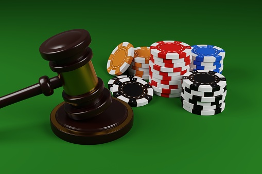 Poker chips and judges gavel on a green background 3D render