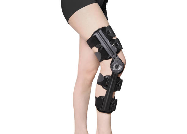 istock Knee Support Brace on leg isolated on white background. Orthopedic Anatomic. Braces for knee fixation, injuries and pain. Knee Joint Bandage Sleeve. Elastic Sports 1353184006