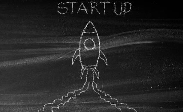 istock Business Startup Concept with Spaceship on Blackboard 1353187209