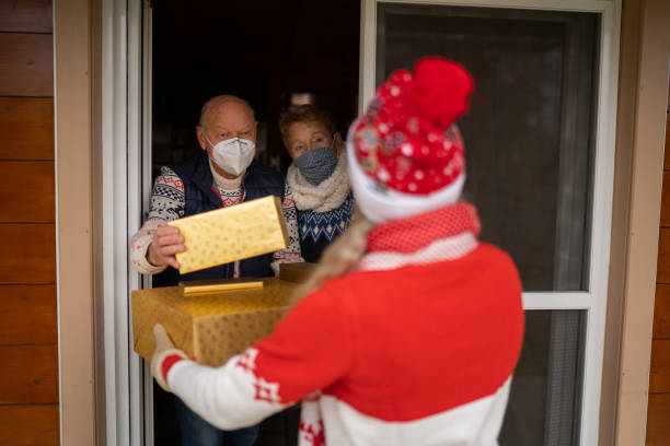 istock Exchanging Christmas Presents at Open Door 1353188140