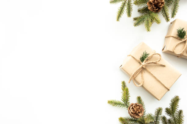 istock Beautiful Christmas background with gift box, decorate with pine branch and pine cone over white background. Top view with copy space, flay lay. 1353188201