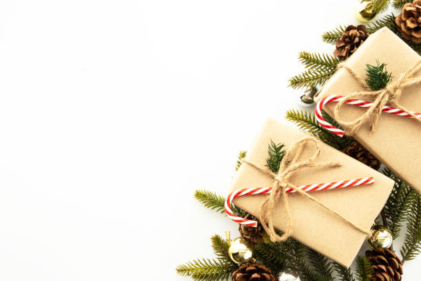 istock Beautiful Christmas background with gift box, decorate with pine branch and pine cone over white background. Top view with copy space, flay lay. 1353188216