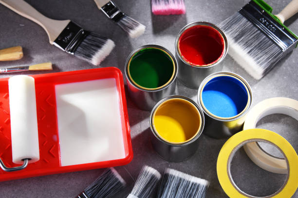 istock Paintbrushes of different size and paint cans 1353189462