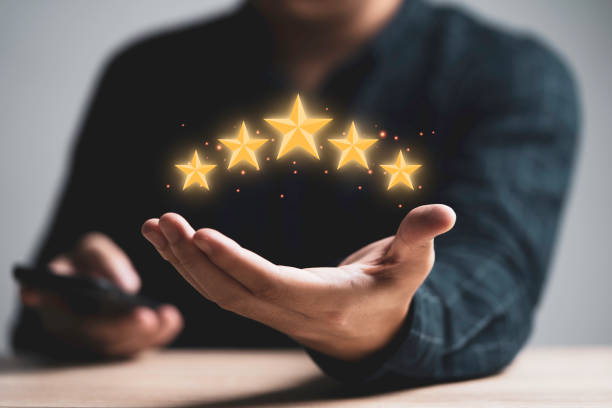 istock Businessman holding golden five stars for client customer feedback and evaluation after use service and product concept. 1353189464