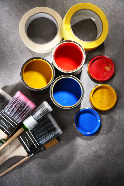 istock Paintbrushes of different size and paint cans 1353189536