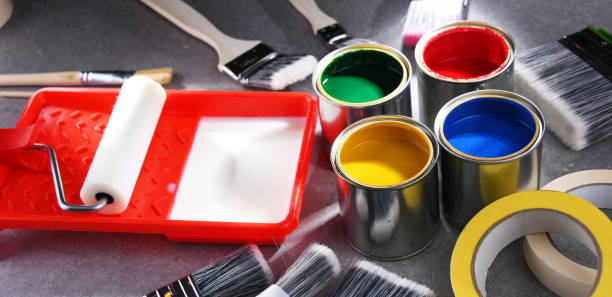 istock Paintbrushes of different size and paint cans 1353189577