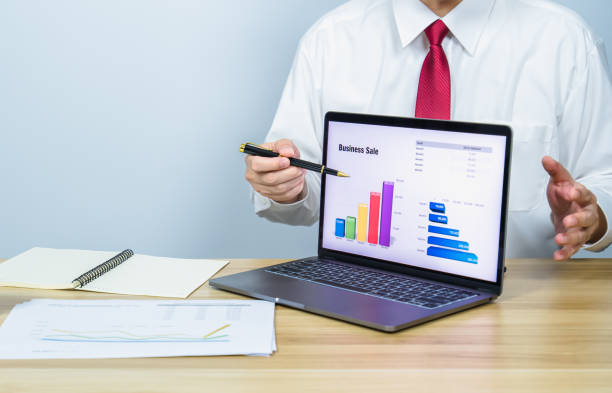 istock executive present graph of business success on laptop by pen 1353190873
