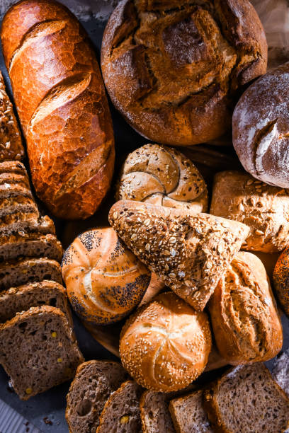 assortiment de produits de boulangerie, y compris des miches de pain et des petits pains - mixed bread photos et images de collection