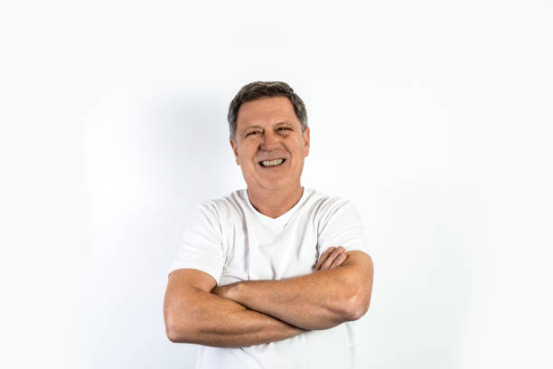 istock handsome man in white shirt with crossed arms 1353191944