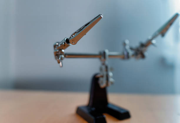 istock Selective focus of an Helping Hands Tool on a wooden desk 1353192175