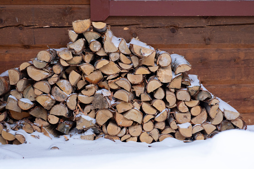 Chopped logs covered in snow