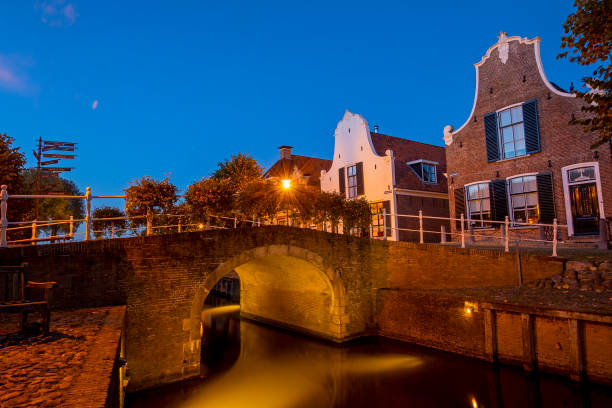 Historical houses in Sloten the Netherlands at sunset Historical houses in Sloten the Netherlands at sunset friesland netherlands stock pictures, royalty-free photos & images