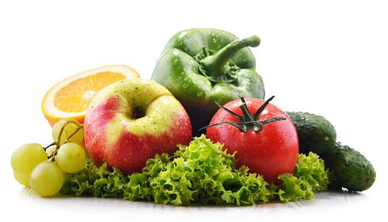 Composition with fresh vegetables and fruits isolated on white background