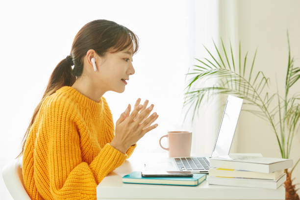 A young Asian woman working at home