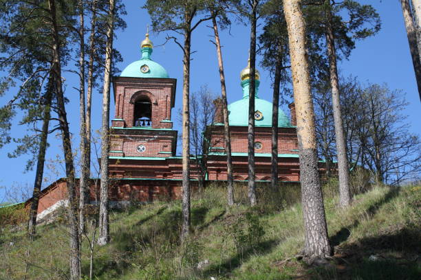 istock Hill, trees, red brick Orthodox church on Valaam Island 1353195984