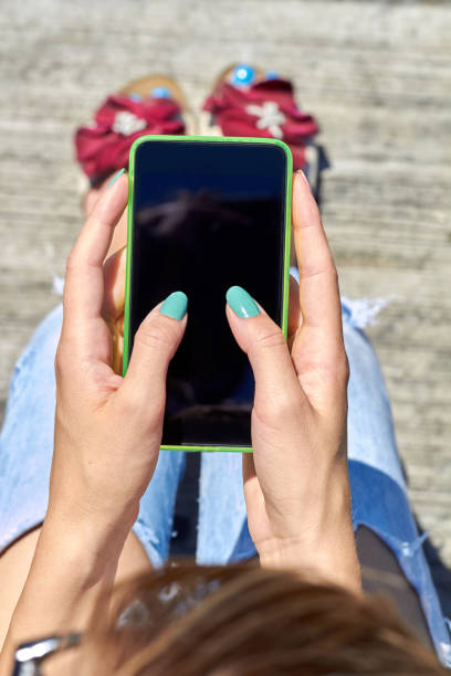 istock Female using modern smartphone outdoors. 1353197003