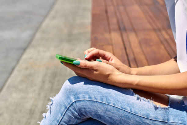 istock Female using modern smartphone outdoors. 1353197029