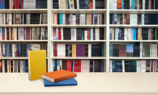 books standing on wooden floor, in front of bookshelf background