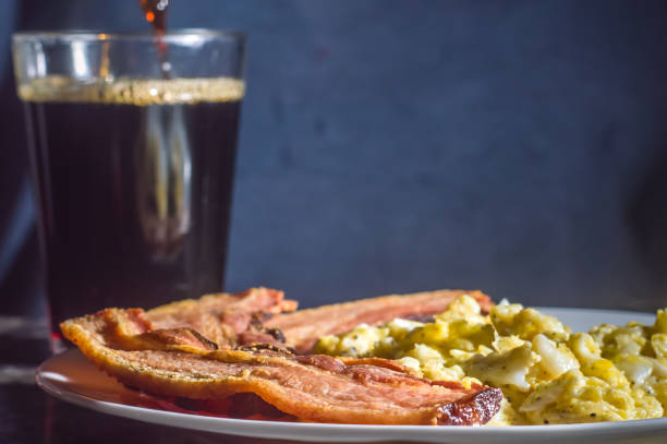 istock sliced bacon on a plate with scrambled eggs and a cup of coffee on the side 1353197726