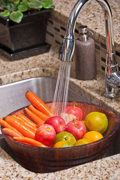 Fruits and veggies in a modern kitchen stock photo