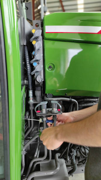 istock Mechanic repairing a tractor. 1353202046
