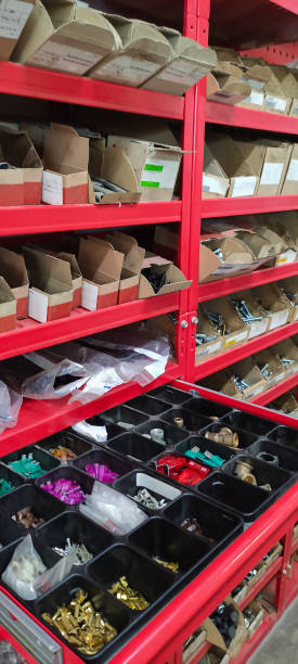 istock Tool box with cells with screws, anchors, nails, bolts and other tools in workshop 1353202120