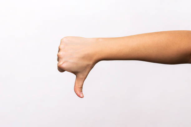 weibliche hand, die die daumen-nach-unten-geste zeigt - rejection stock-fotos und bilder