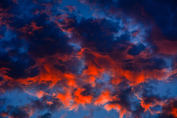 istock Red sunset clouds in the blue sky 1353208090