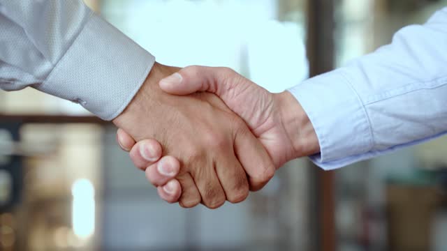 Two businessmen shake hands with business handshake concept.