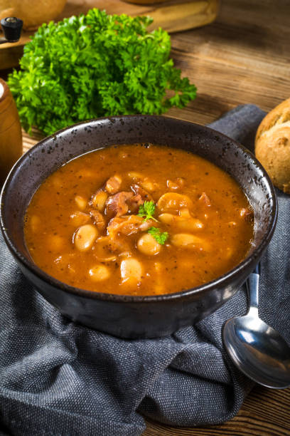 istock Beans with tomato sauce, bacon and sausage. 1353210634