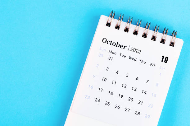 istock October 2022 desk calendar on blue background. 1353211913