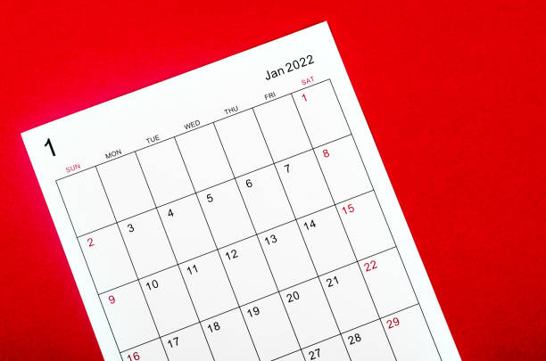 istock January 2022 calendar sheet on red background. 1353211935