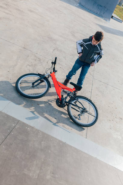 istock Boy After Jumping With Bike 1353216560