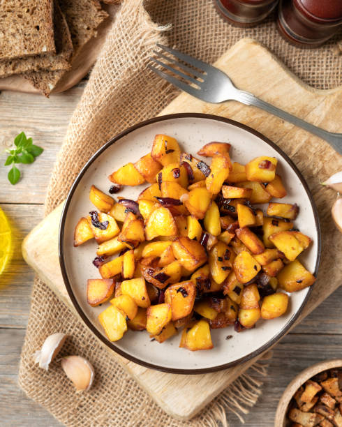 istock Fried potatoes in a plate on a gray wooden table top view 1353216933