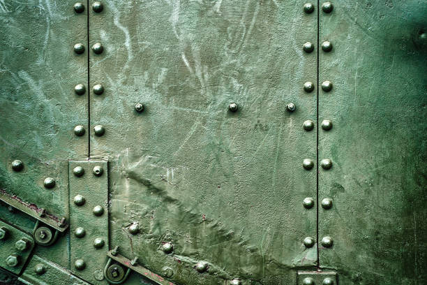 Abstract green industrial metal background texture with bolts and rivets. Old painted metal background, detail of military aircraft, surface corrosion, metal texture with rivets stock photo