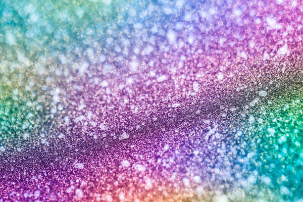 istock Shimmering purple sandy background with wavy texture and blur. Macro image of a metallized shiny multicolored surface 1353218243