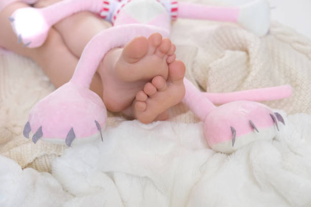 Photo of a little baby girl, celebrating her first birthday cowered in confetti. Studio shot.