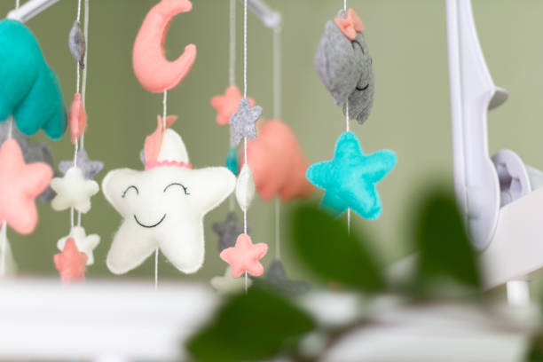 istock Textile soft toys rotate over the baby's crib. mobile for the cradle. 1353220084